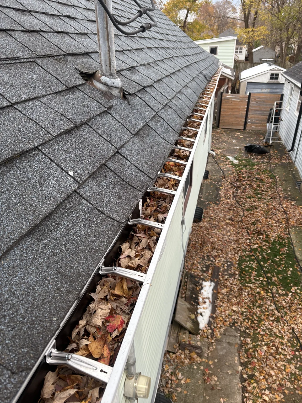 Gutter filled with leaves before cleaning